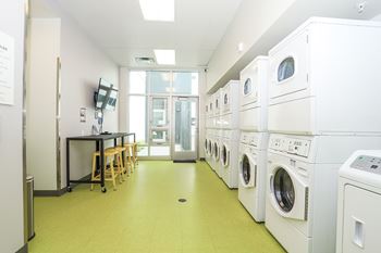 A laundry room with washers and dryers. at RiDE at RiNo Apartments, Denver